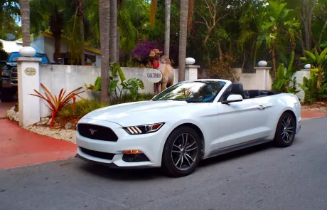 A white Ford Mustang Cabriolet parked in front of a hotel in Islamorada in the Florida Keys