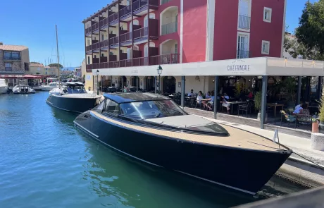 A gold black yacht on the canals of Port Grimaud in the south of France