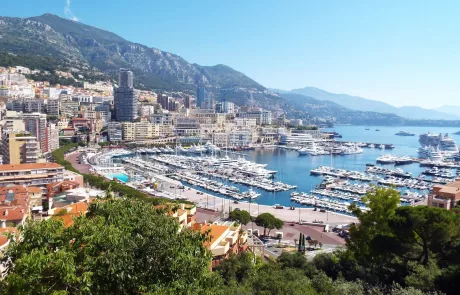 a view over the bay in monaco which shows the sea and many yachts and building nestled into the mountains