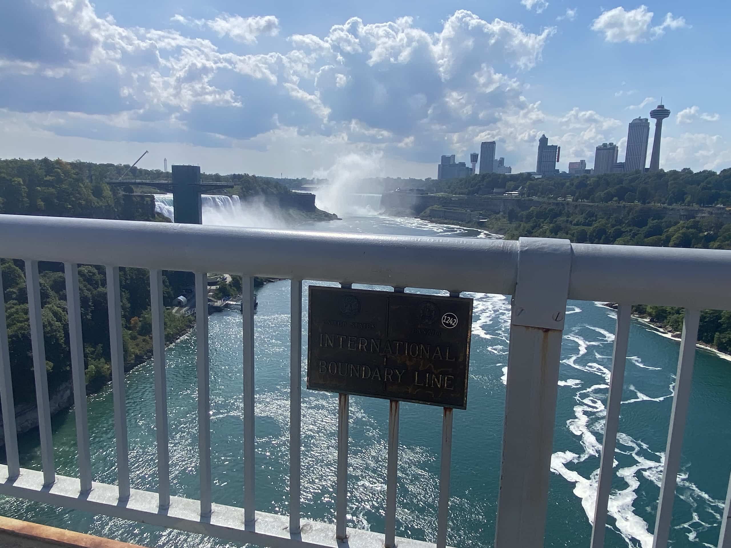 East_Coast_Roadtrip_Niagara_00002 A sign showing the international boundary line in the middle of the Rainbow bridge connecting USA and Canada at Niagara Falls