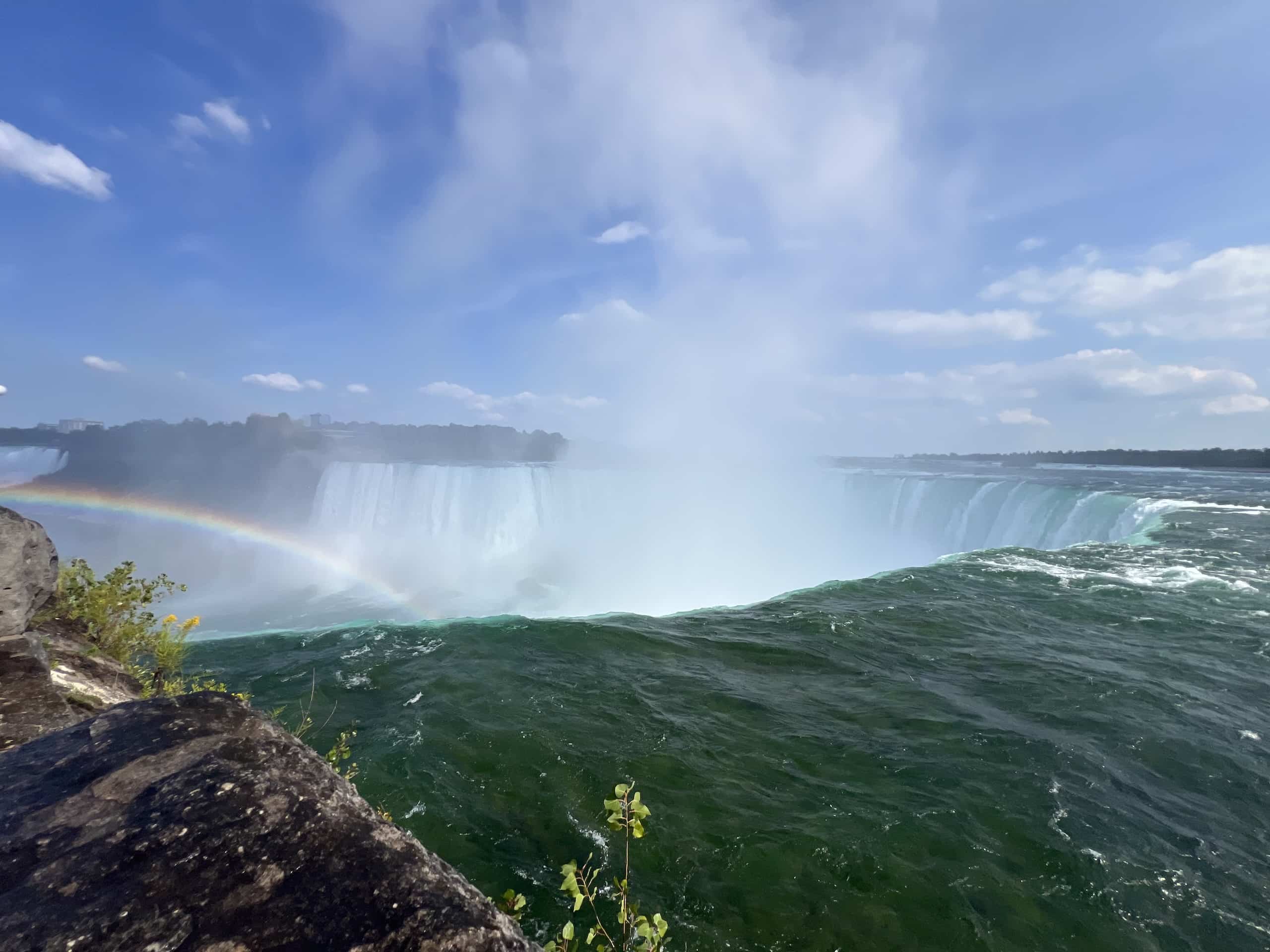 East_Coast_Roadtrip_Niagara_00013 Looking over the edge of Boagara Falls with a rainbow in the background through the water spray andmist