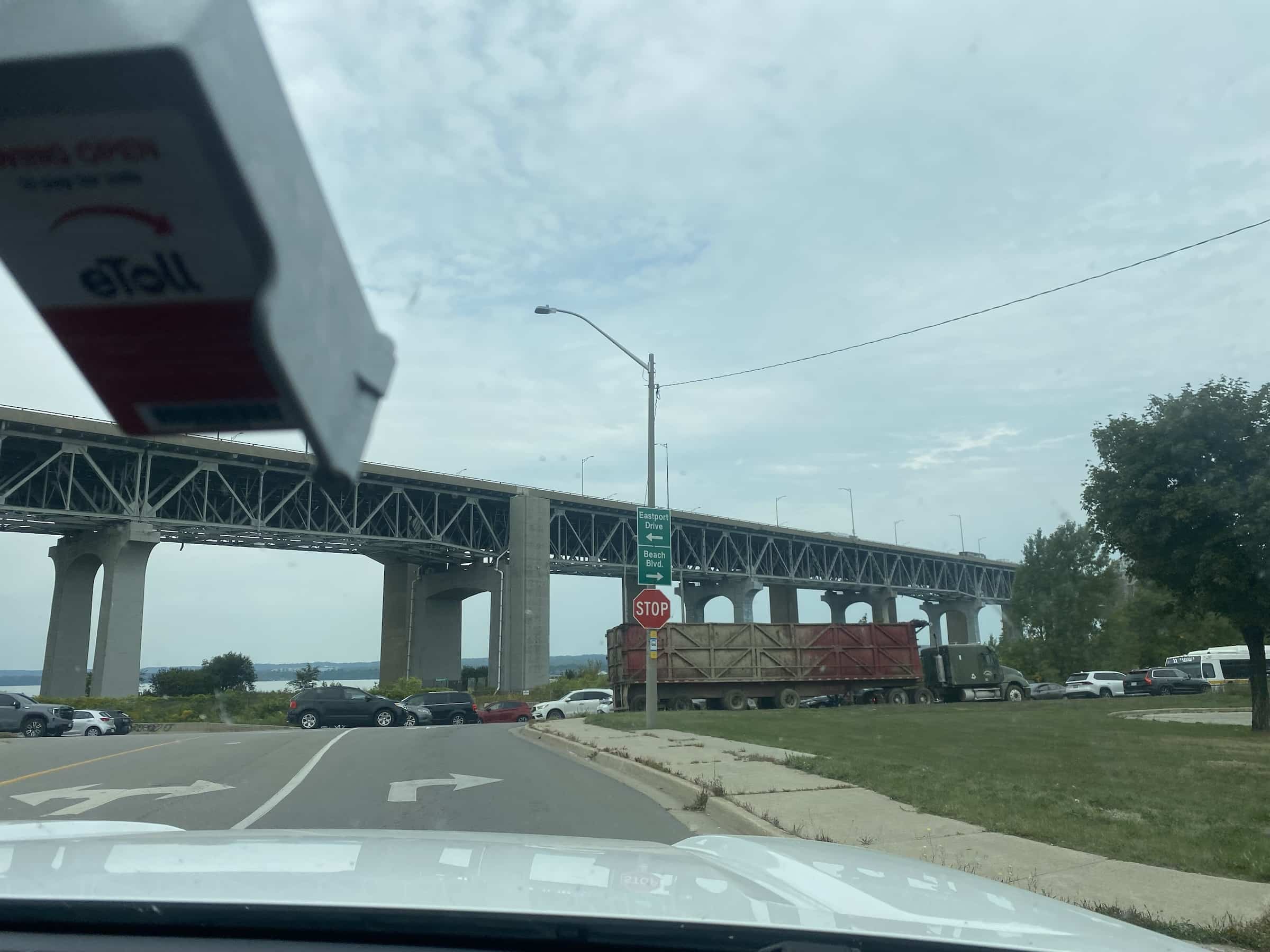 East_Coast_Roadtrip_views_from_passenger_side_gallery_01-00036 an iron bridge with concrete struts goes across a main road in canada